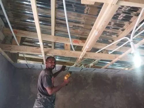 Man installing ceiling panels