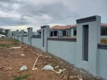 Modern grey perimeter wall and house