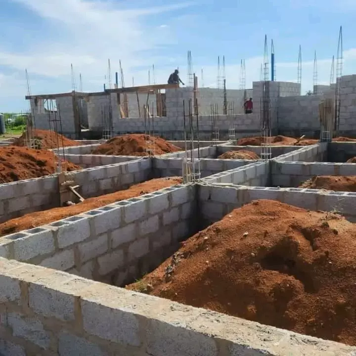 Building construction foundation with concrete blocks and red soil