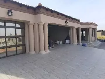 Exterior facade of a modern beige building with classical columns