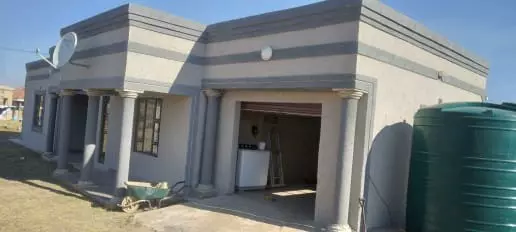 Modern single-story residential house with pillars and garage