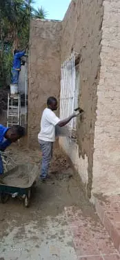 Construction workers plastering an exterior wall